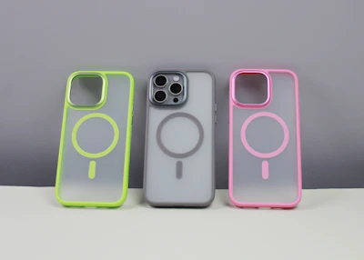 A close-up of quirky phone cases with bold, playful patterns on a clean white background.