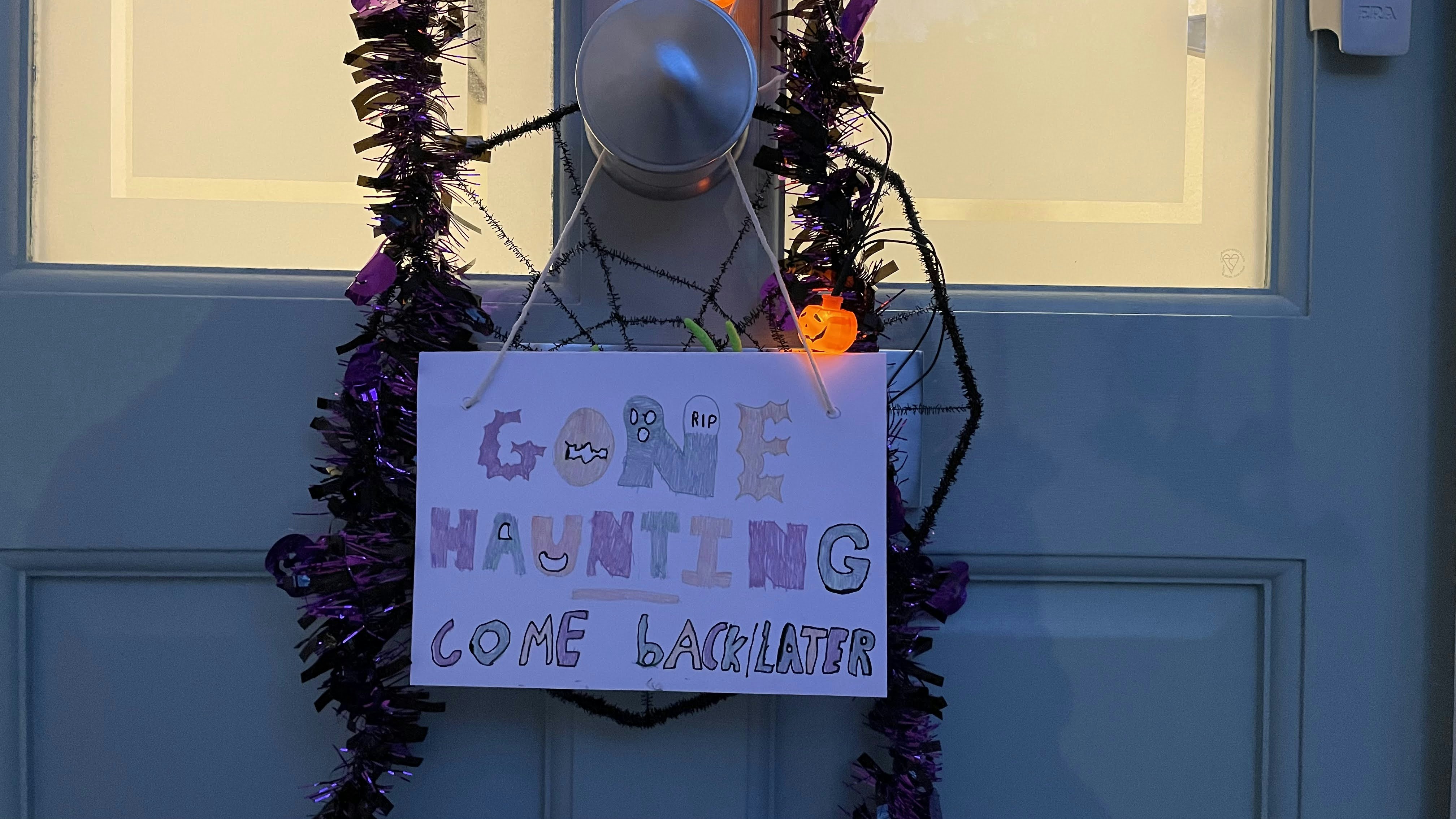 a sign on a door that says gone to the halloween zone