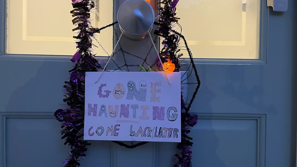 a sign on a door that says gone to the halloween zone