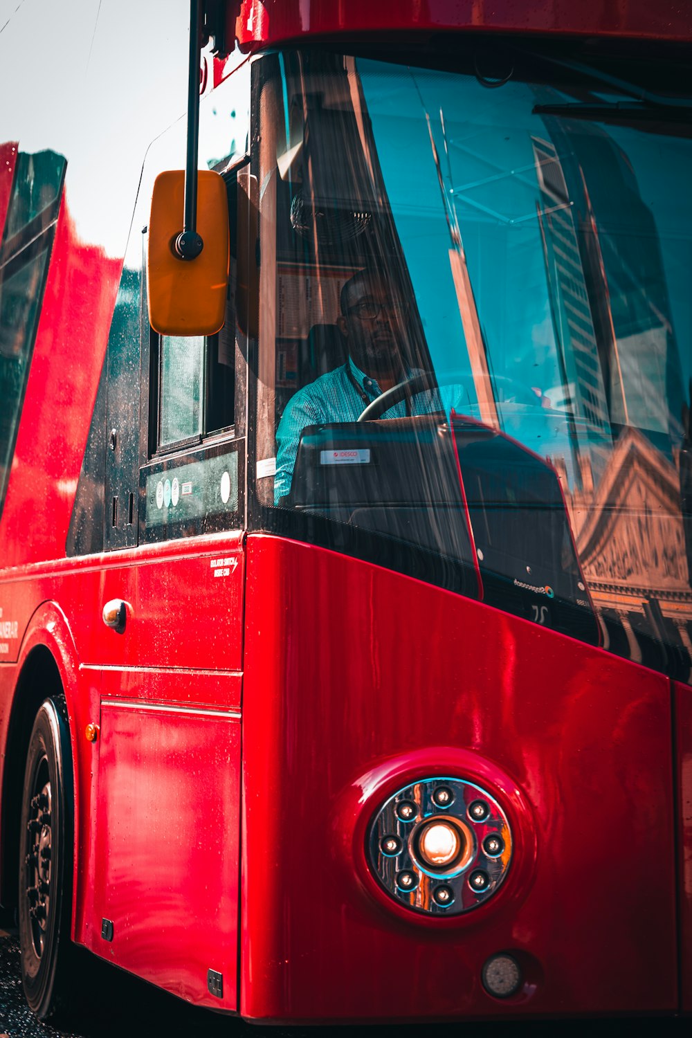 a red bus parked on the side of the road