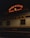 A vintage train car is parked at a station under a neon sign that reads 'Union Station Travel by Train'. The train car is labeled 'Pullman' and 'Suitsme', with a classic design typical of early 20th-century railcars.
