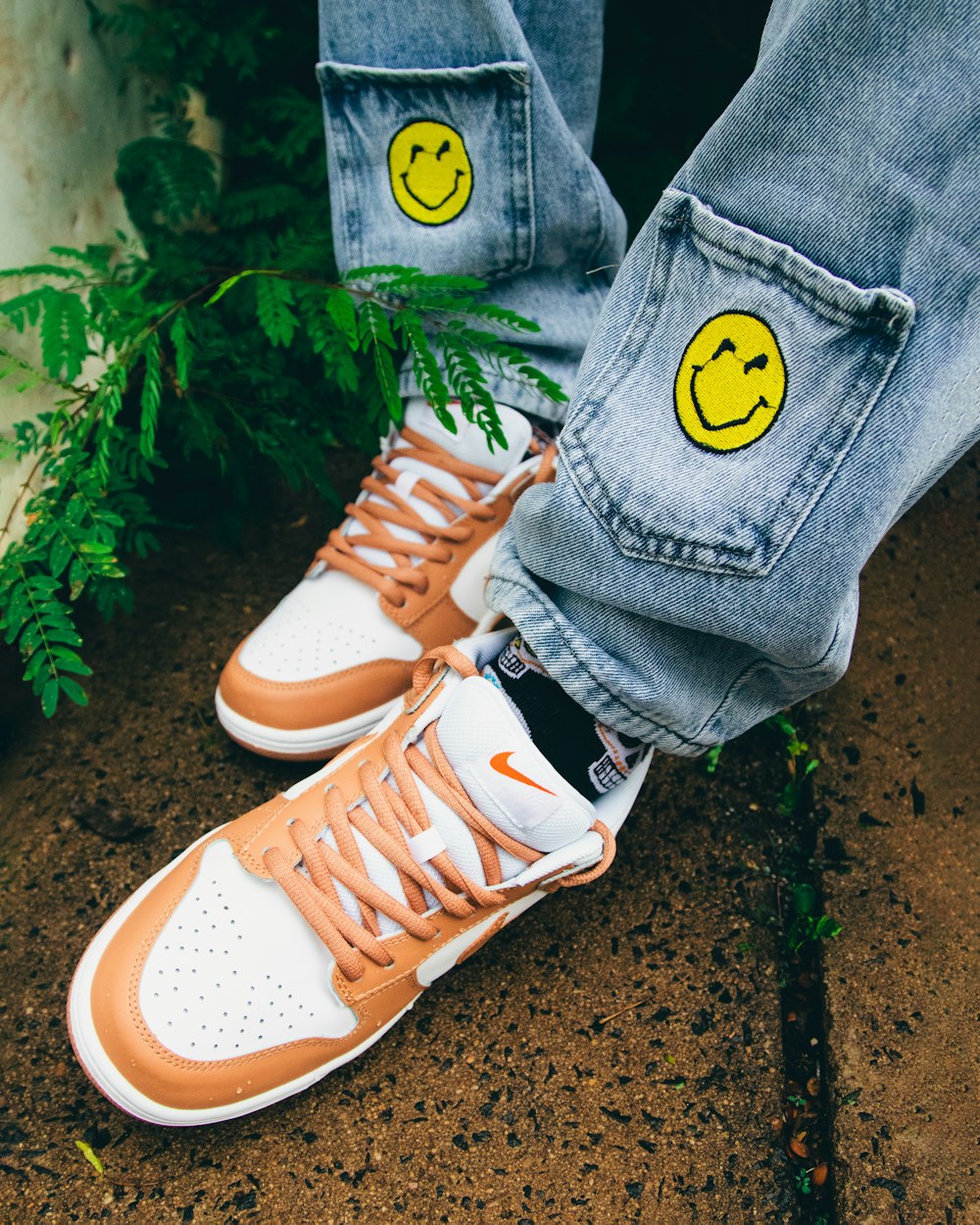 a pair of sneakers with smiley faces painted on them