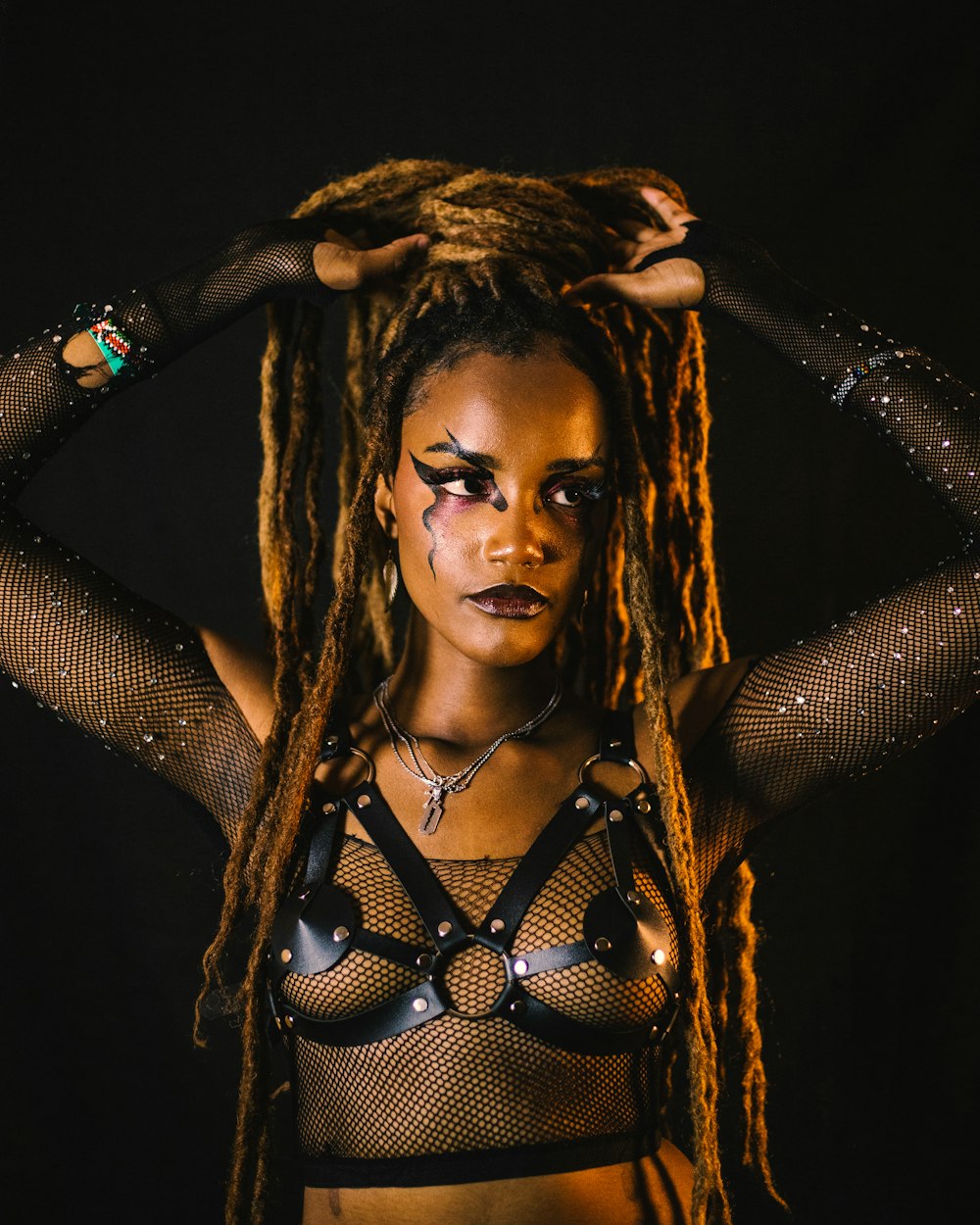 a woman with dreadlocks and a bra