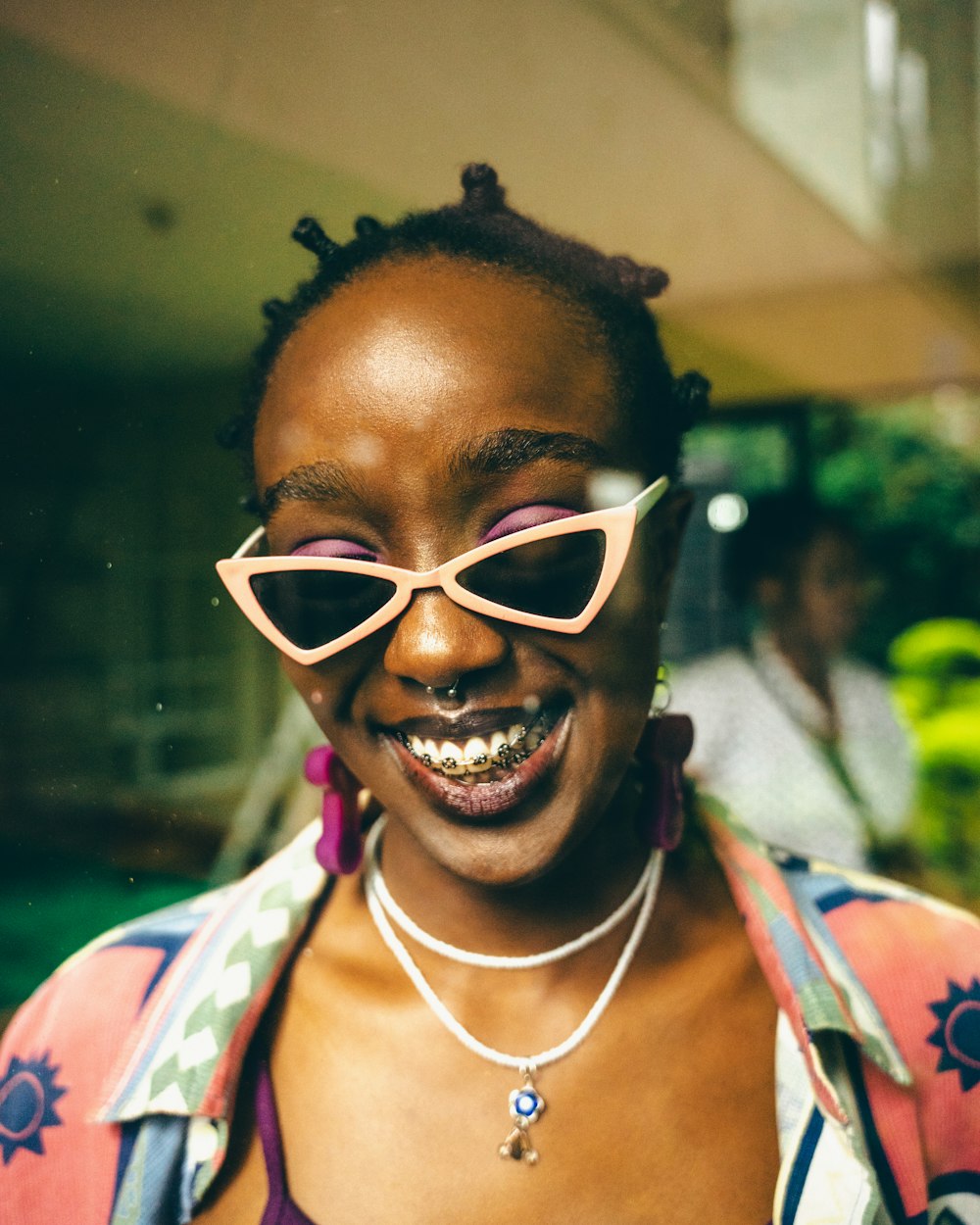 a woman wearing a pair of pink sunglasses