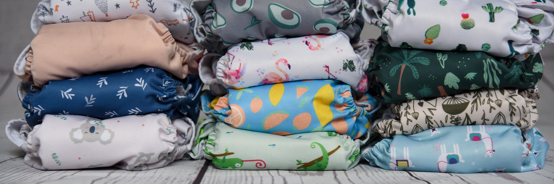 a stack of cloth diapers sitting on top of a wooden floor