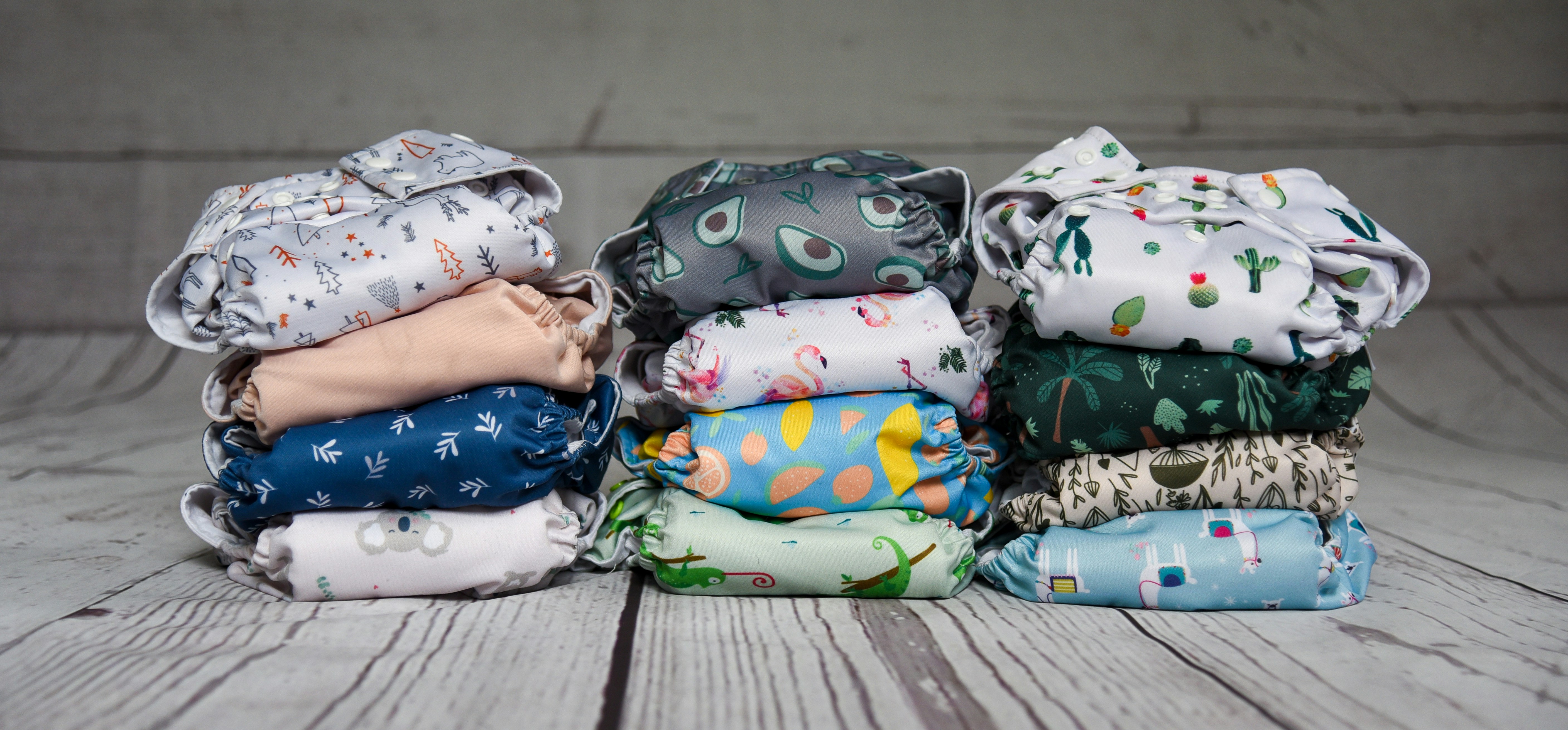 a stack of cloth diapers sitting on top of a wooden floor