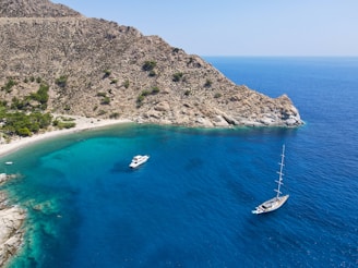 a couple of boats floating on top of a body of water