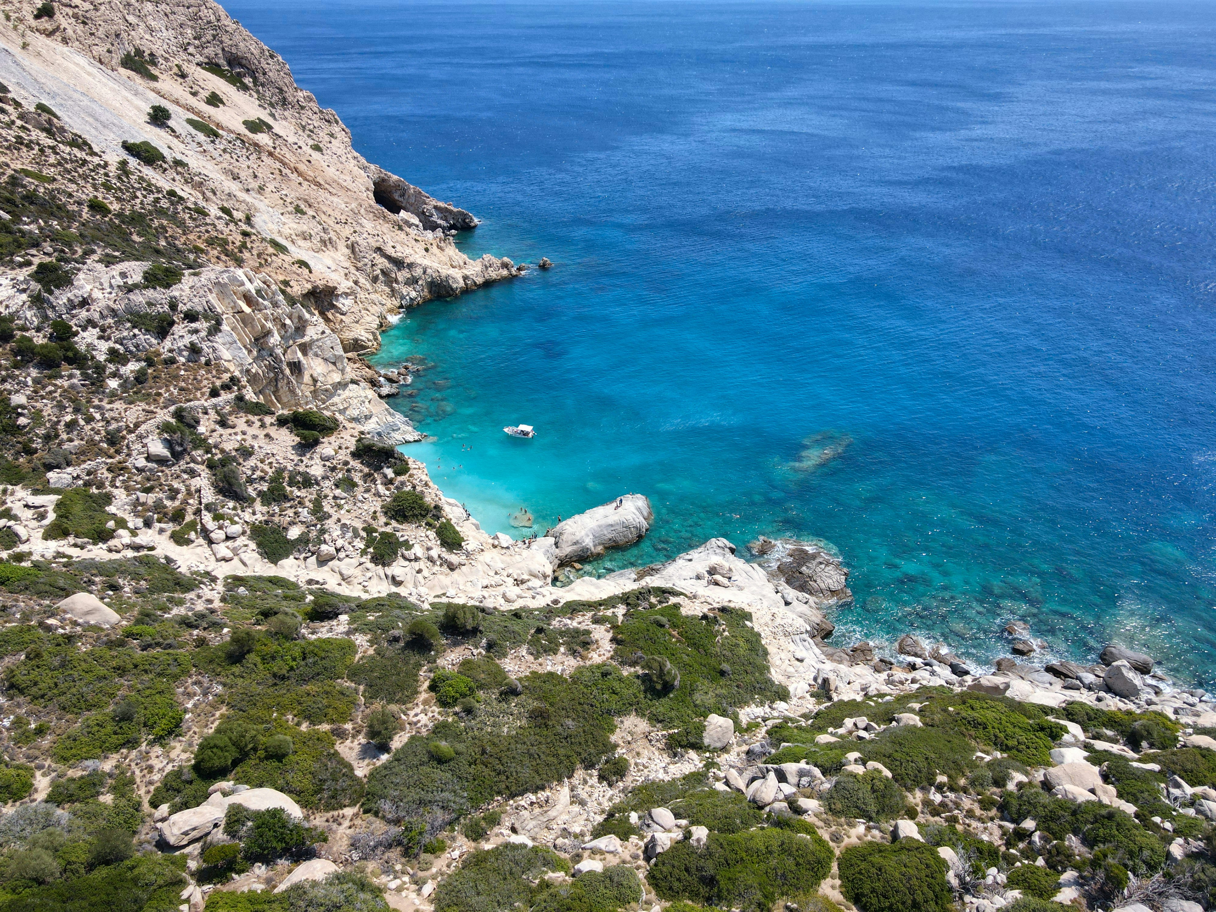 a view of a body of water near a cliff, A view above Seychelles beach, Ikaria island, Greece.