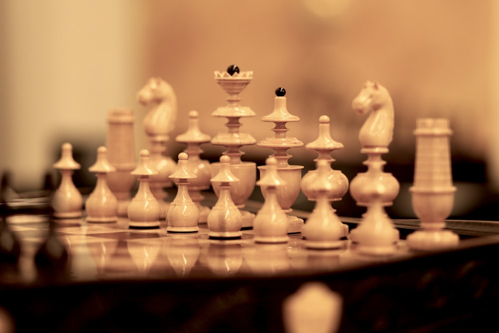 a close up of a chess board with pieces on it