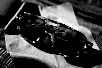 Stylish sunglasses resting on a textured surface with a warm color palette