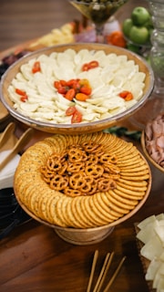 An overhead shot of a variety of colorful appetizers arranged on a rustic wooden table