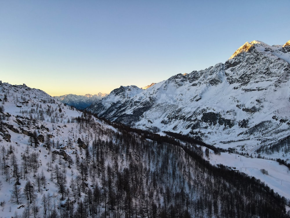 a snow covered mountain with a lake below