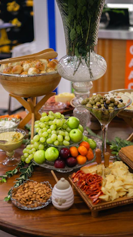 Close-up of a colorful, appetizing spread of fresh catering dishes on a rustic wooden table.