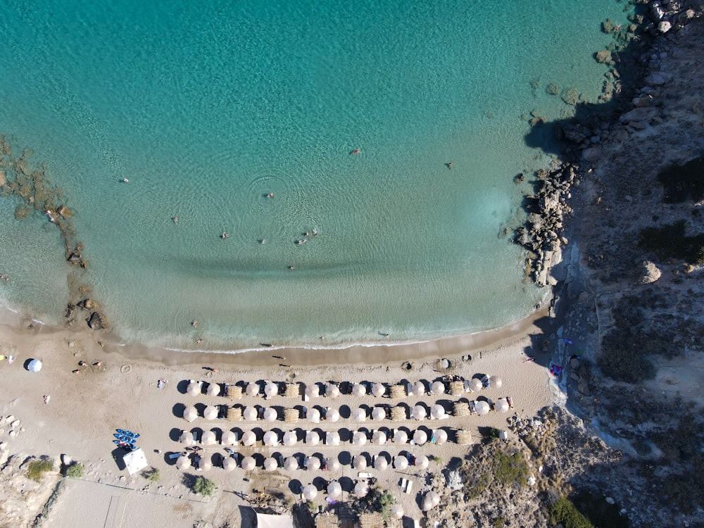 an aerial view of a beach with a lot of umbrellas