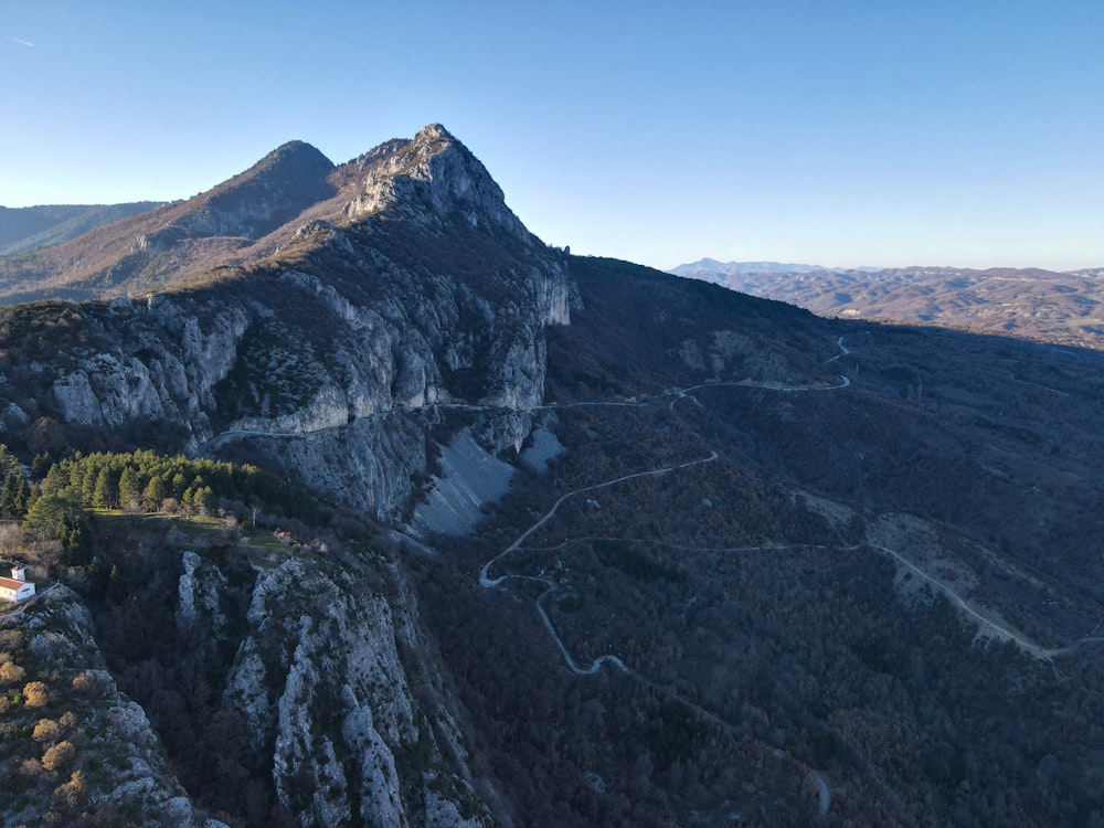 an aerial view of a mountain with a road going through it