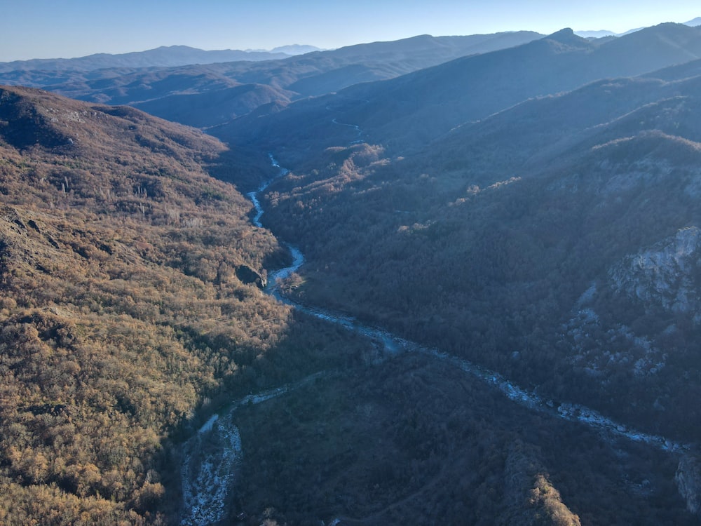 a river running through a valley surrounded by mountains