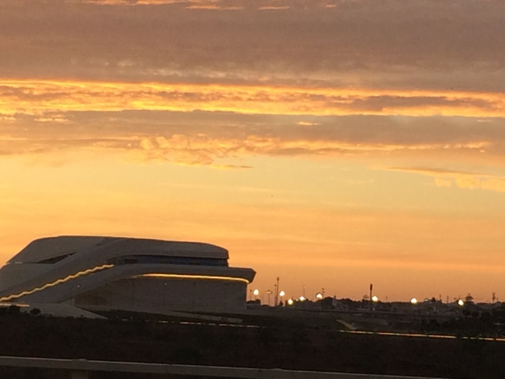 a plane is flying in the sky at sunset