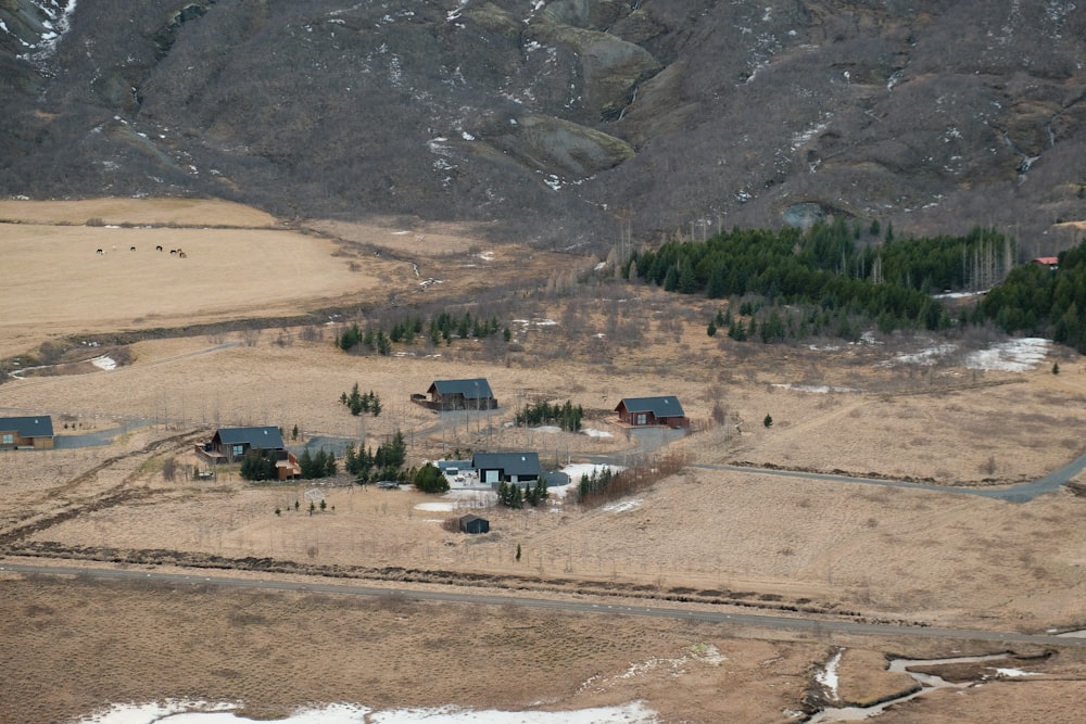 an aerial view of a farm in the mountains