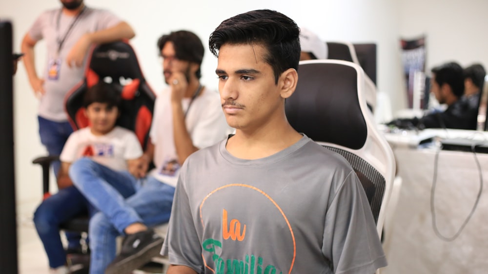 a man sitting in a chair in front of a group of people