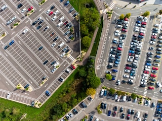 an aerial view of a parking lot with cars parked in it