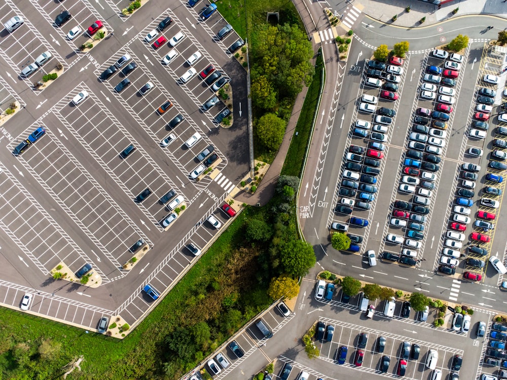 an aerial view of a parking lot with cars parked in it