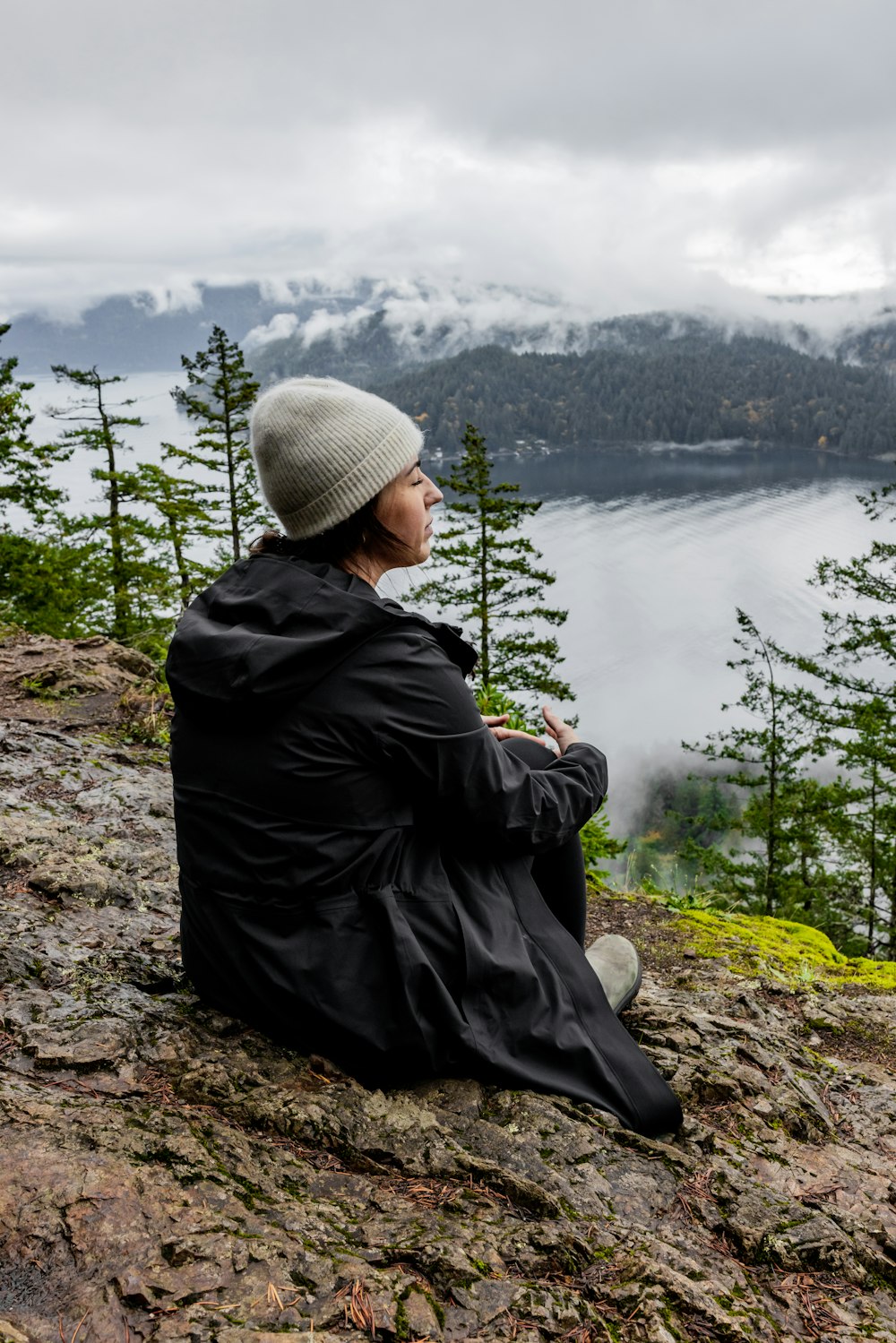 a person sitting on top of a rocky hill