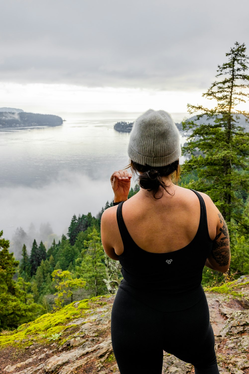 a woman standing on top of a mountain