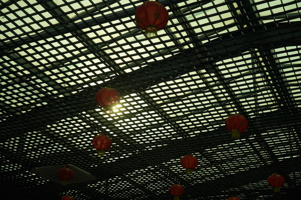red lanterns hanging from the ceiling of a building