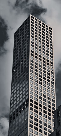 a very tall building with a very cloudy sky in the background