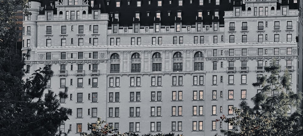 a large white building with many windows and a clock