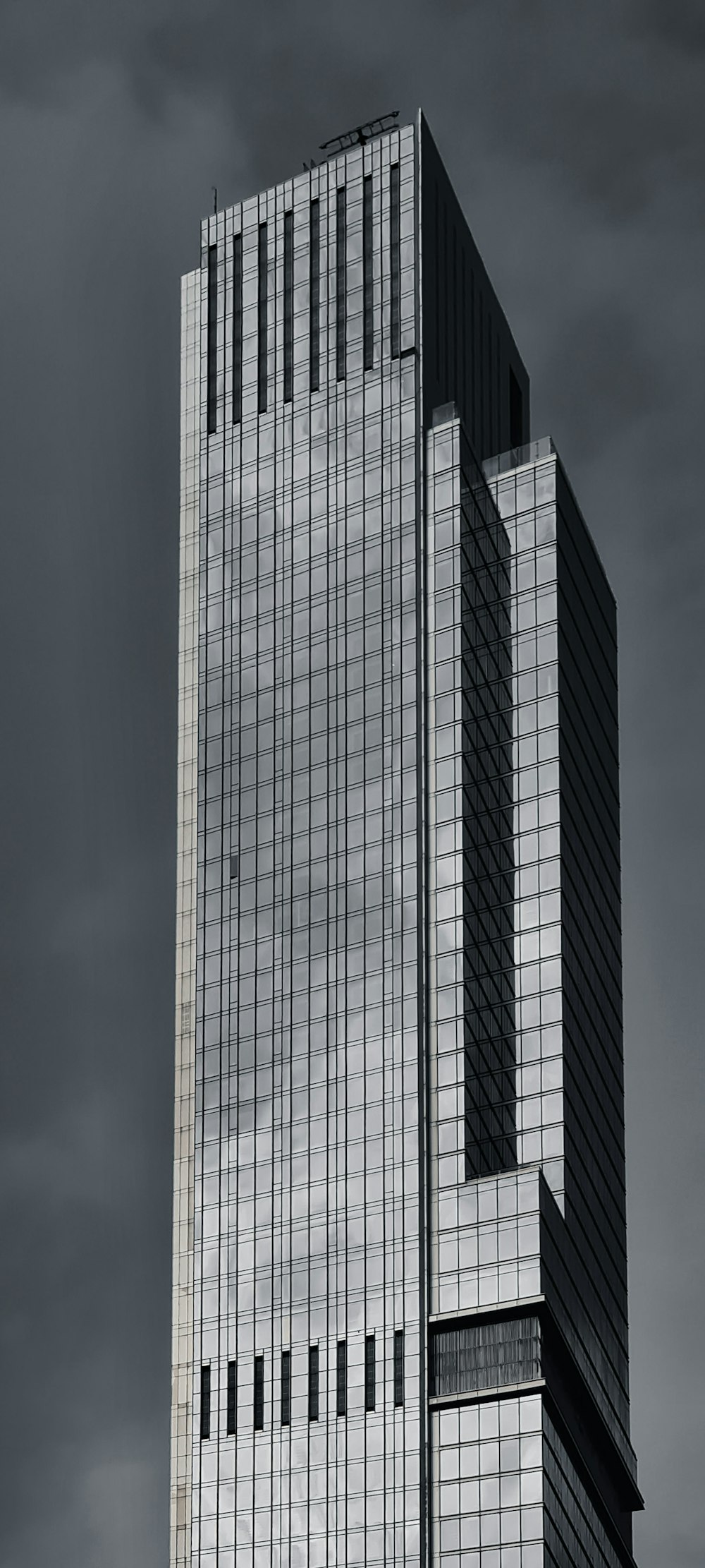 a very tall building sitting under a cloudy sky