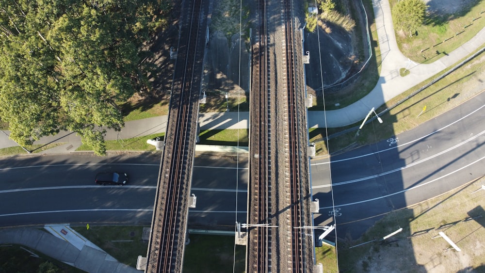 an aerial view of a train track and a street