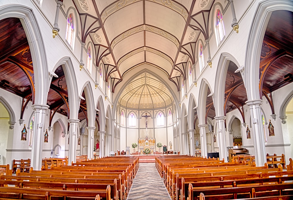 a large church with rows of wooden pews