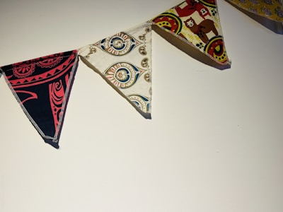 Wall flags with delicate pastel patterns hanging in a bright showroom setting.