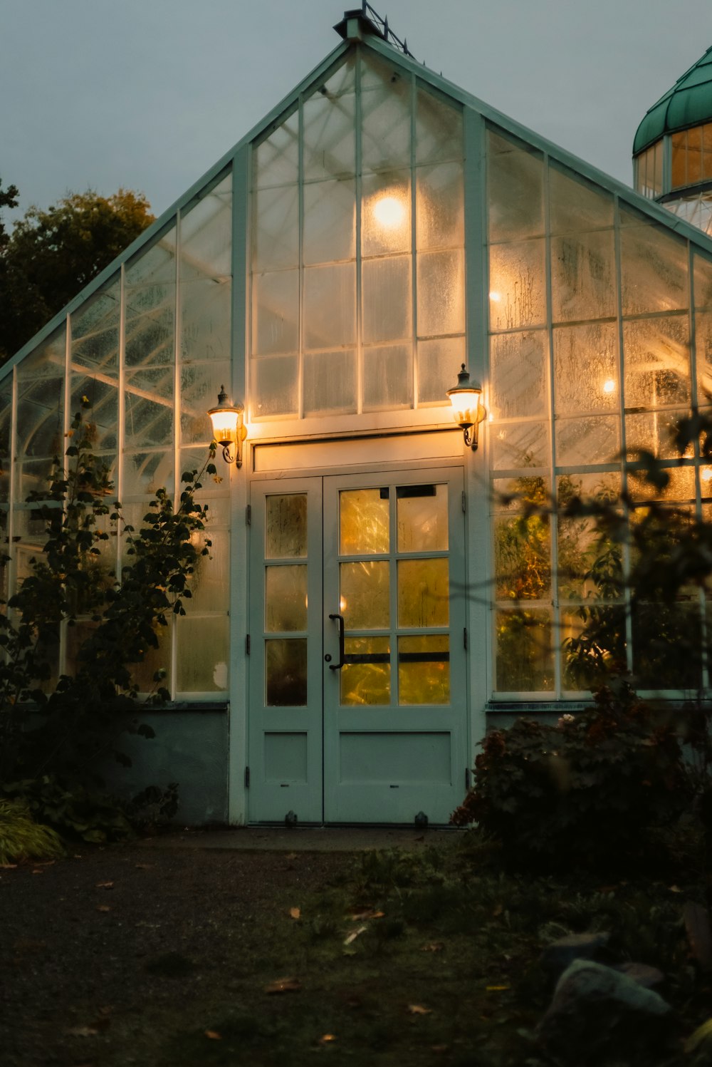 a green house with a white door and windows