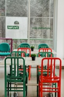 Bright dining area with red, yellow, and black decor filled with happy customers.