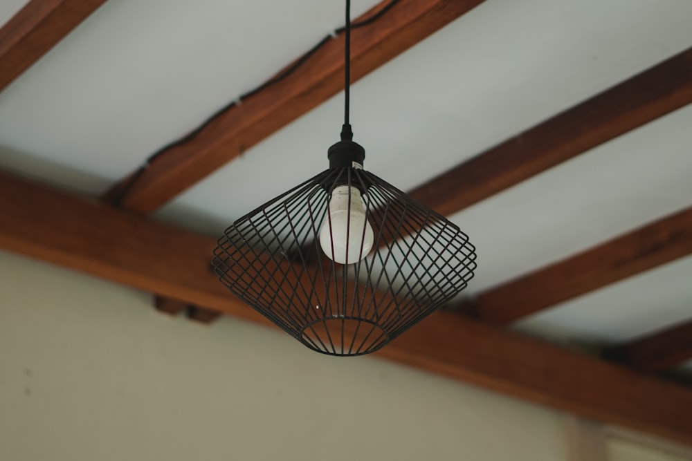 a caged light fixture hanging from a ceiling