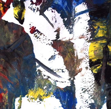 An abstract painting featuring bold, expressive brushstrokes in a mix of colors including blue, yellow, red, black, and white. The composition is dynamic and textured, creating a sense of movement and intensity.