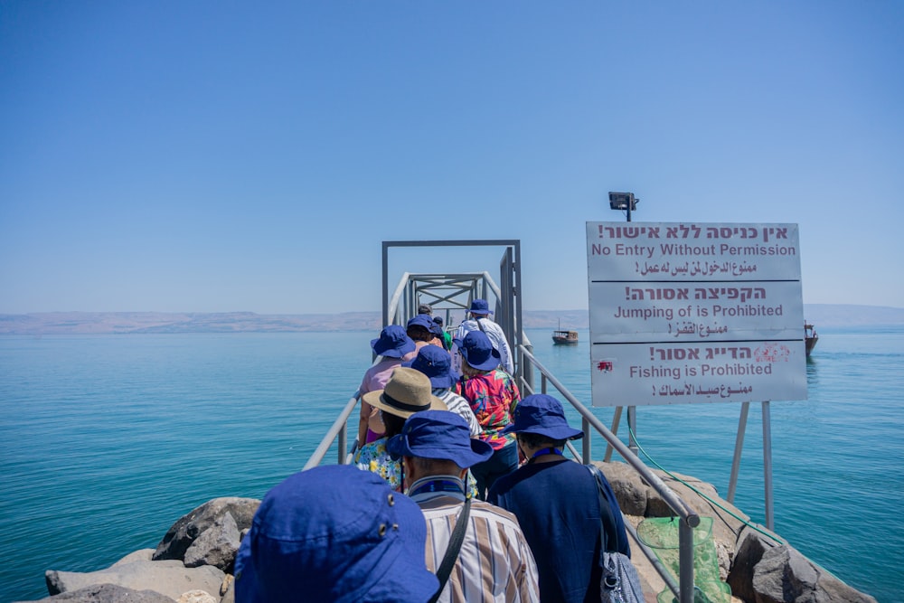 a group of people standing on top of a bridge