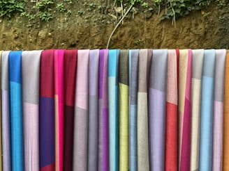 a row of colorful towels hanging on a clothes line