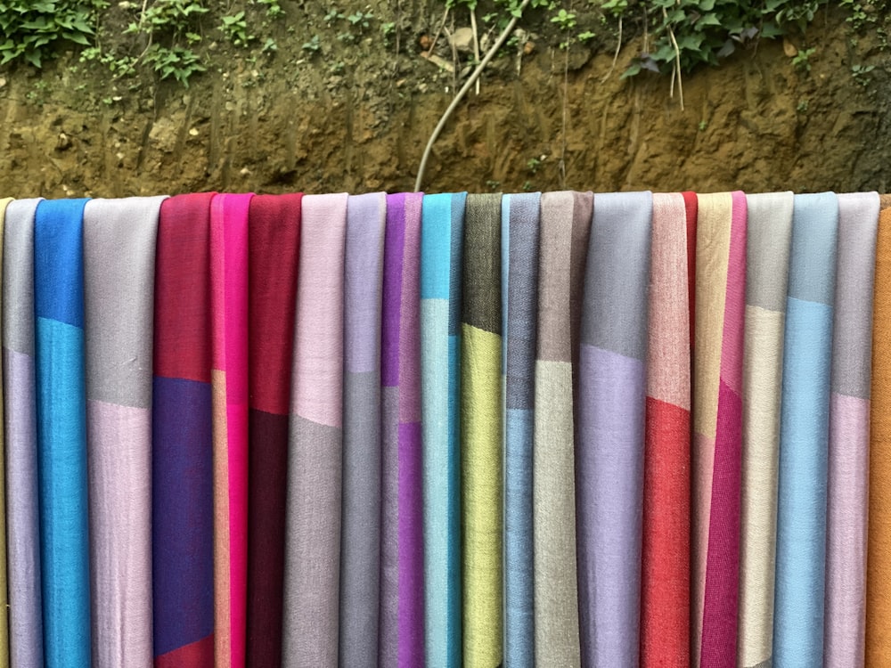 a row of colorful towels hanging on a clothes line