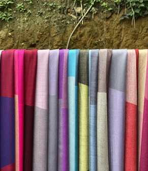 a row of colorful towels hanging on a clothes line