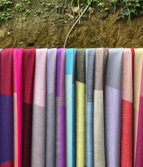 a row of colorful towels hanging on a clothes line