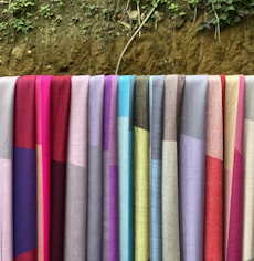 a row of colorful towels hanging on a clothes line