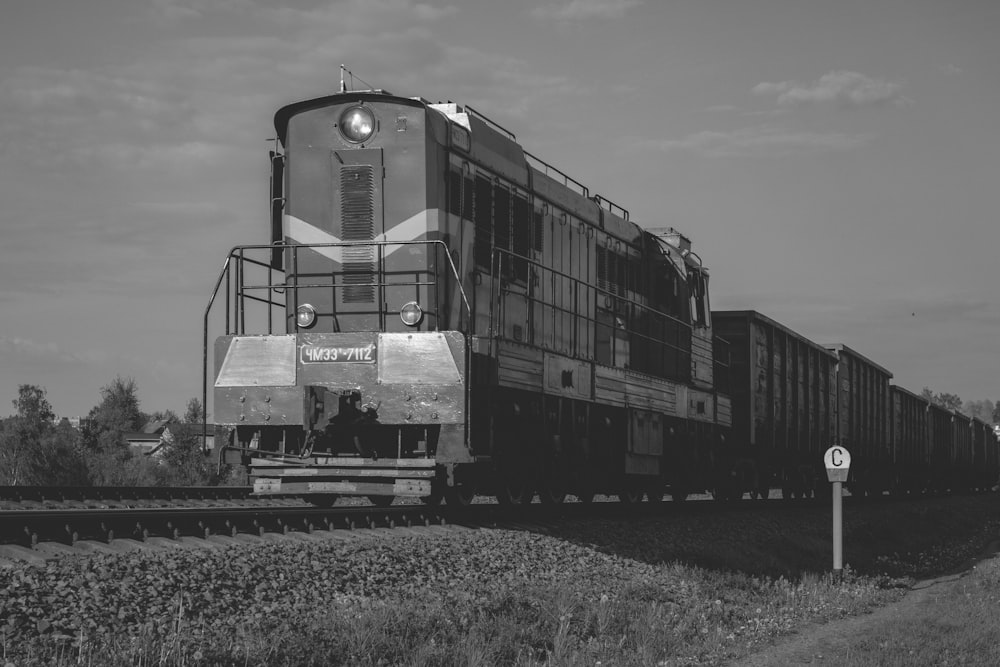 a black and white photo of a train on the tracks