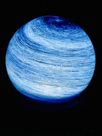 Luxurious blue marble background with subtle golden astrological symbols glowing softly.