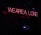 Red neon text saying 'WE ARE ALL ONE' in uppercase letters against a dark background. The sign is positioned diagonally.