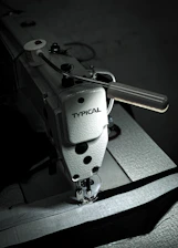 Industrial sewing machine stitching polypropylene bag closing thread.