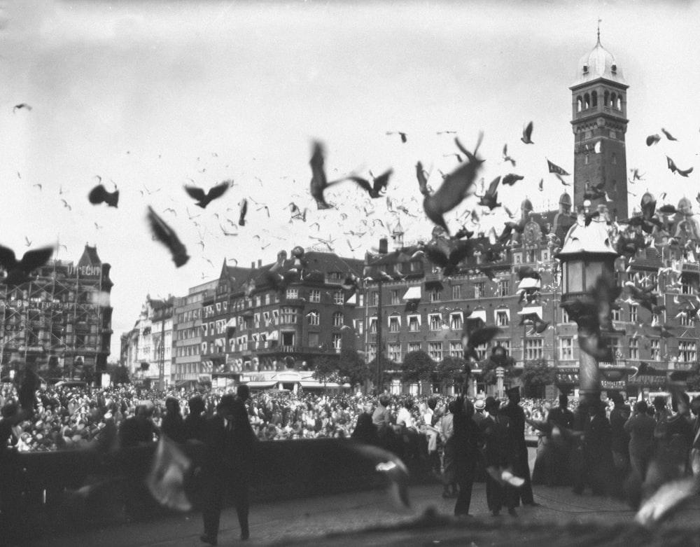 a crowd of people standing around a clock tower