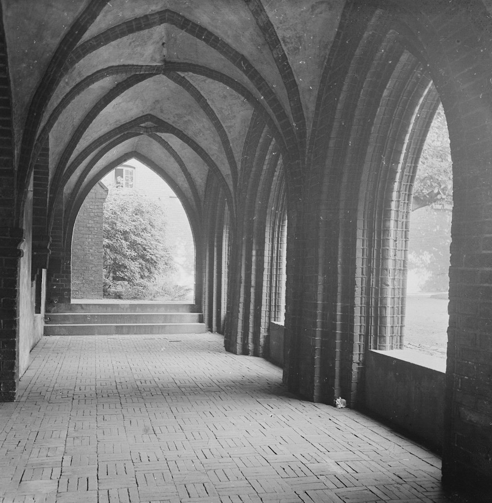 a black and white photo of an arched walkway